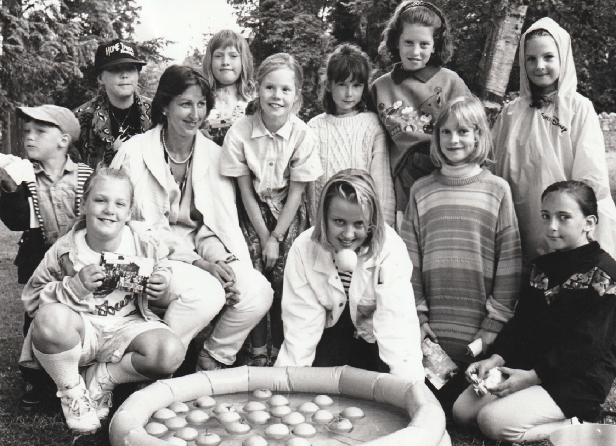 OPEN: Michelle Charles, from BBC TV’s Byker Grove, opened the Grange-over-Sands Junior School’s summer fair in 1993. She is pictured at the duck apple stall run by Marion Turner with some of the pupils who attended