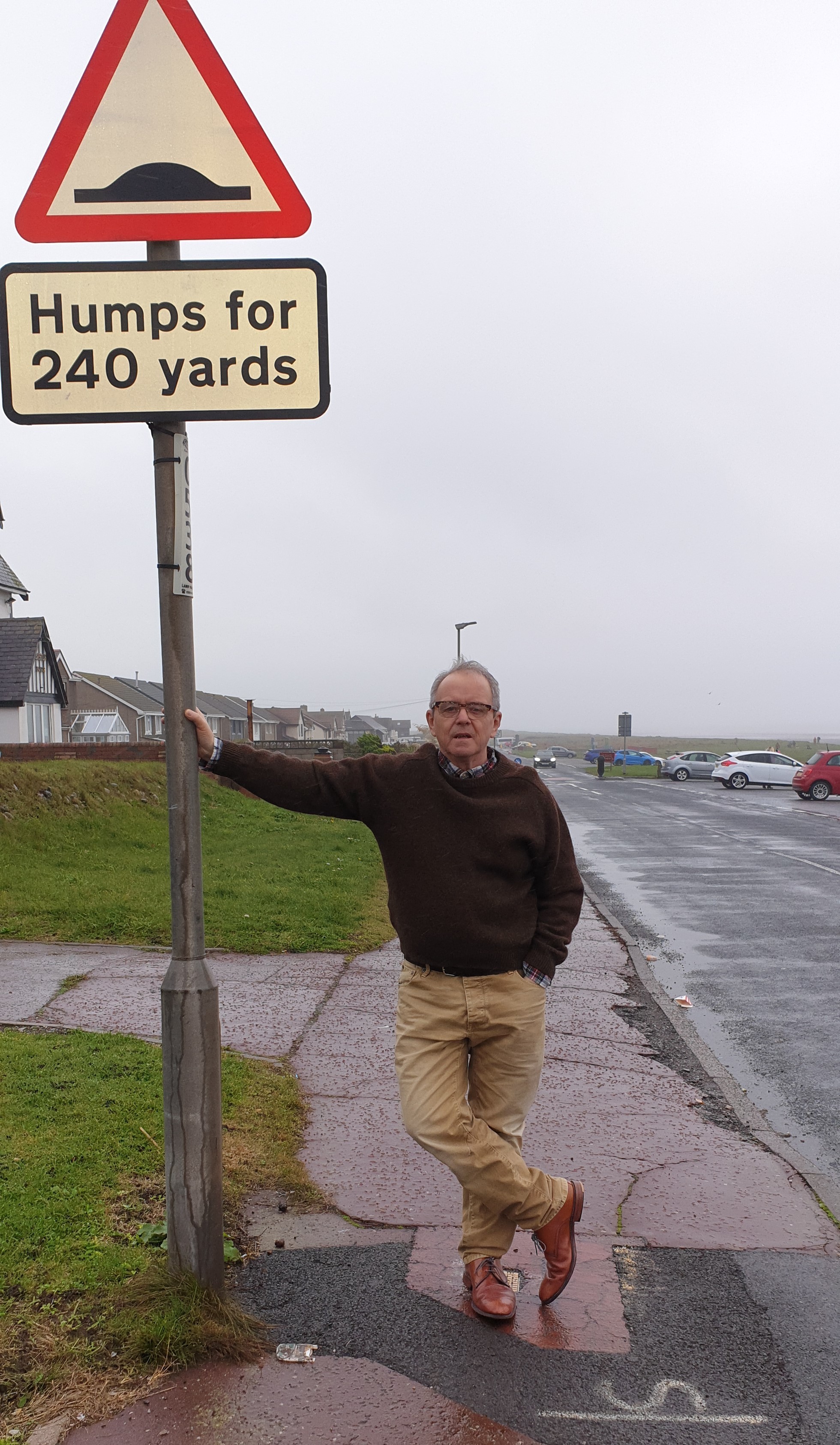 SLOW DOWN: Cllr Frank Cassidy next to new sign